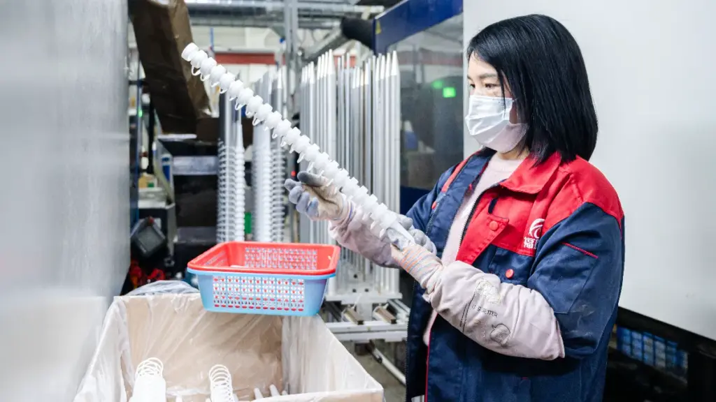 worker holds plastic caps