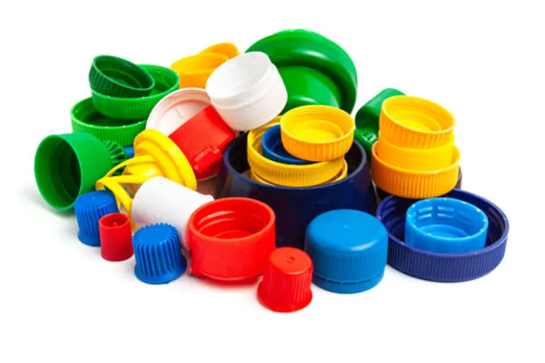 Colored plastic caps from bottles of water isolated on a white background